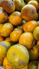 Close up pile of tasty fresh oranges sold at the market as a background.