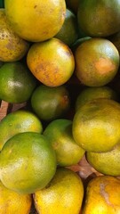 Close up pile of tasty fresh oranges sold at the market as a background.
