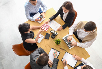 Group of business people working at table in conference hall, top view