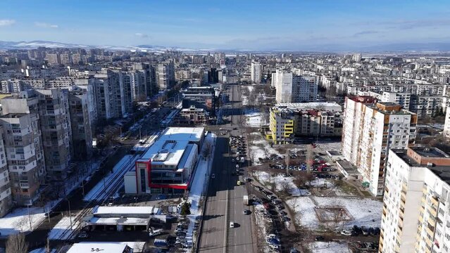 Drone footage of the cars driving on roads between the urban buildings in winter in Sofia, Bulgaria