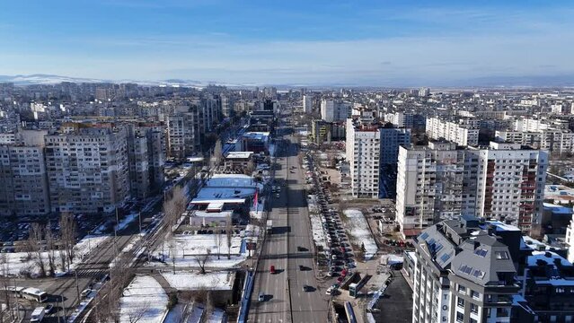 Drone footage of the cars driving on roads between the urban buildings in winter in Sofia, Bulgaria