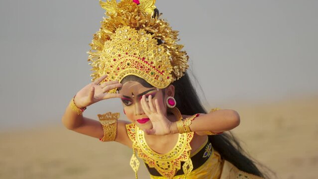 Graceful and elegant balinese dancer with headdress, jewelry, and makeup, asia