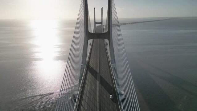 Drone flyover shot of Vasco da Gama bridge over Tagus river in Lisbon Portugal destination