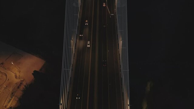 Drone flyover shot of Vasco da Gama bridge over Tagus river in Lisbon, Portugal at night