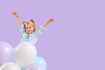 Fototapeta na wymiar Cute little girl with beautiful balloons on purple background
