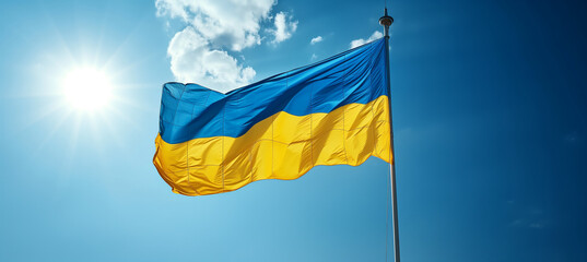 Waving Ukraine flag against clear sky. National identity and patriotism