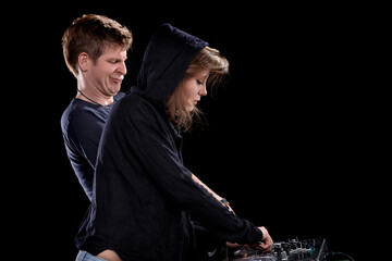 Pointing DJs showcase teamwork on stage confidently