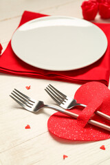 Beautiful table setting for Valentine's Day with hearts on white wooden background