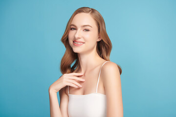Beautiful young woman with clean fresh skin on blue background, Face care, Facial treatment,...