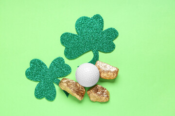 Golf ball, gold and clovers on green background. St. Patrick's Day celebration
