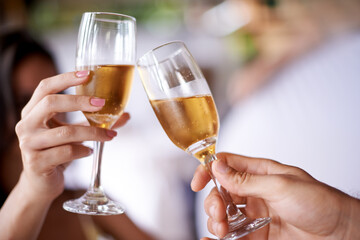 Hands, couple and glass with champagne to toast, celebrate and anniversary with date for bonding. Closeup, relationship and cheers for love with bubbles for romance on vacation, support and care.