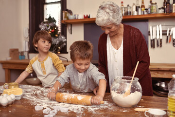 Grandmother, smile and kids baking in kitchen, learning or happy boys bonding together in home....
