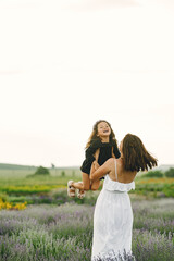 Little girl with her mother in a lavender field