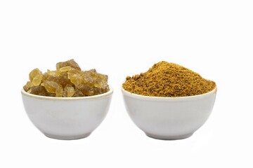 Tal Mishri and Granulated Sugarcane Jaggery in a White Bowls Isolated on White Background with Copy Space in Horizontal Orientation, Also Known as Rock Sugar or Palm Sugar