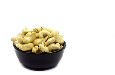 Cashew Nut Dried Fruit in Black Bowl Isolated on White Background in Horizontal Orientation with Copy Space, Healthy Eating and Lifestyle Food Concepts