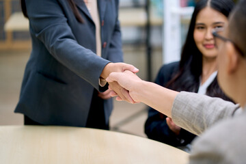 Commitment hand shake concept , Businessman and woman shak hand together in meeting room office.