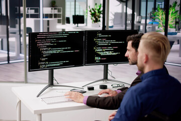 Computer Programmer Writing Program Code On Computer
