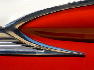 Classic vintage car - abstract detail on the side of an old red and white retro American car.