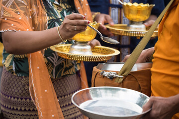 Mon people offer jasmine rice and food to monk, Sangkhlaburi