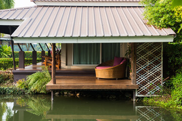 Sofa bed on patio by canel of luxury resort in Thailand