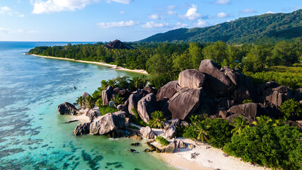 Drone top view at Anse Source d'Argent beach, La Digue Island, Seychelles, Drone aerial view of La Digue Seychelles,tropical vacation summer holiday, beach with huge granite rocks at sunset
