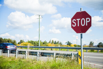 Stop road sign beside highway
