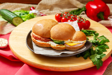 The sandwich is large with ham, cheese, cucumber and sauce. Fast food.