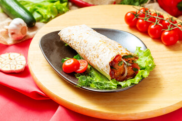 Pork shish kebab in pita bread with vegetables. Fast food.