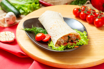 Fototapeta na wymiar Shawarma, pork doner in pita bread with vegetables. Fast food.