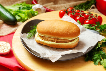 Sandwich with fish cutlet and sauce. Fast food.