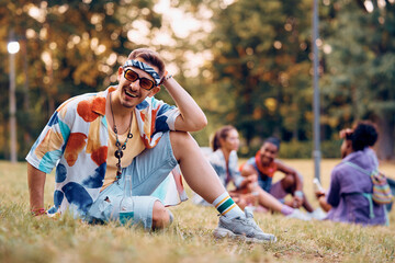 Cheerful festival goer in park during summer looking at camera.