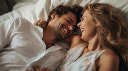 Close-up of a beautiful happy contented couple lying in bed and laughing. Family Life, Love, Lifestyle, Positive Emotions concepts.