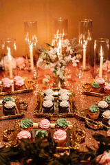 fancy wedding treat table with cupcakes and candles