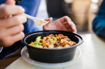 Person eating a takeout meal