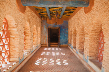 An elaborate hallway leading to a door in ancient Africa.