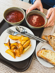 Fried potatoes borscht and bread on the table