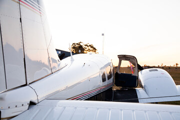 Private twin engine aeroplane on rural landing strip at dusk