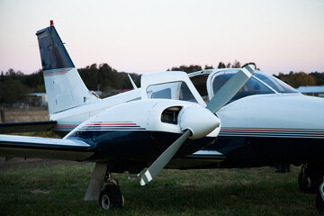 Private twin engine aeroplane on rural landing strip at dusk