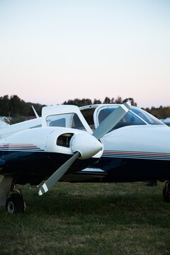 Private twin engine aeroplane on rural landing strip at dusk