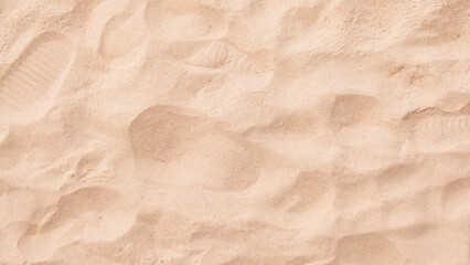 Background image of fine sand at the beach for adding desired text.