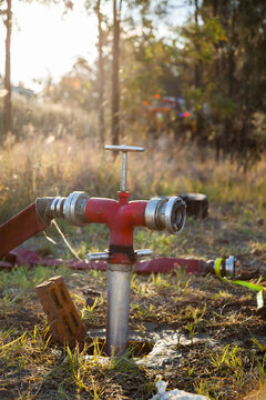 Fire Hydrant for fighting rural fires with hose attached and sun flare