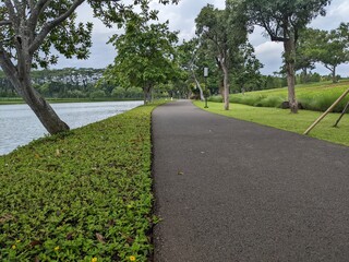 Mini jogging park on the Semarang Central Java with lake, cloudy vibes and blue sky. The photo is...