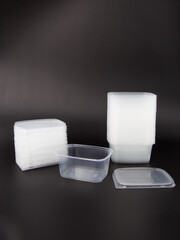 Lots of Empty plastic disposable food container, transparent lid isolated on black background.