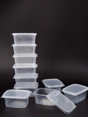 Lots of Empty plastic disposable food container, transparent lid isolated on black background.