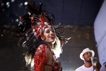 Night, woman or dancer with samba at carnival in rio de janeiro for brazilian festival with feather costume or smile. Person, face or party with dancing, fashion or music for culture or outdoor event