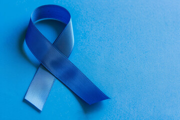 Royal Blue Awareness Ribbon on Light Blue Textured Background, Copy Space