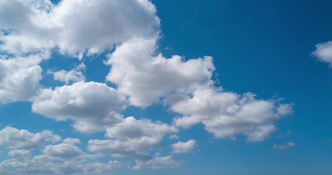 Blue sky with clouds background. Sky clouds slow motion. Clouds blue slow mo. Blue sky with clouds and sun timelapse. Flying cloudscape. Timelapse of white cloud moving.