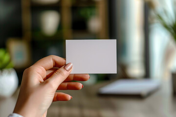 Woman's hand holding a blank business card in a stylish office setting. Ai Generated.