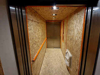 office equipment via a personal elevator must be sealed and covered with boards to protect the stainless steel interior of the luxury elevator. construction work and reconstruction © Michal