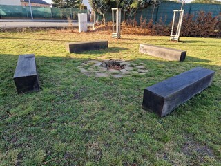 rustic bench made of halved debarked logs with legs made of logs. serves most often in parks in the countryside and by the fireplace. the undemanding shape and strength of wood will withstand decades